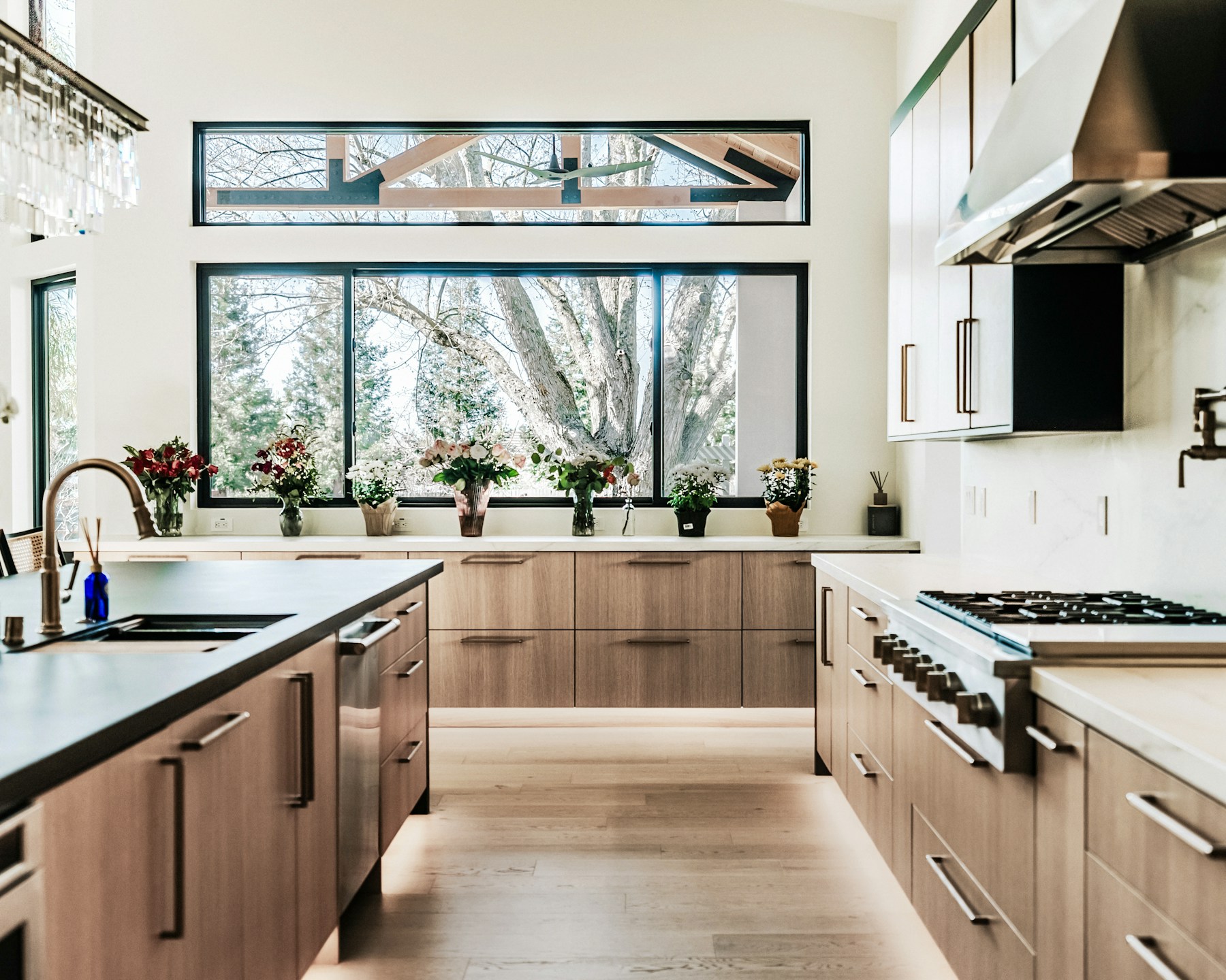 Warm modern kitchen with custom wood cabinetry and stone counters